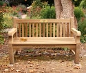 crown logo carved into a garden bench