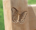 Butterfly crest engraved into one of our teak benches